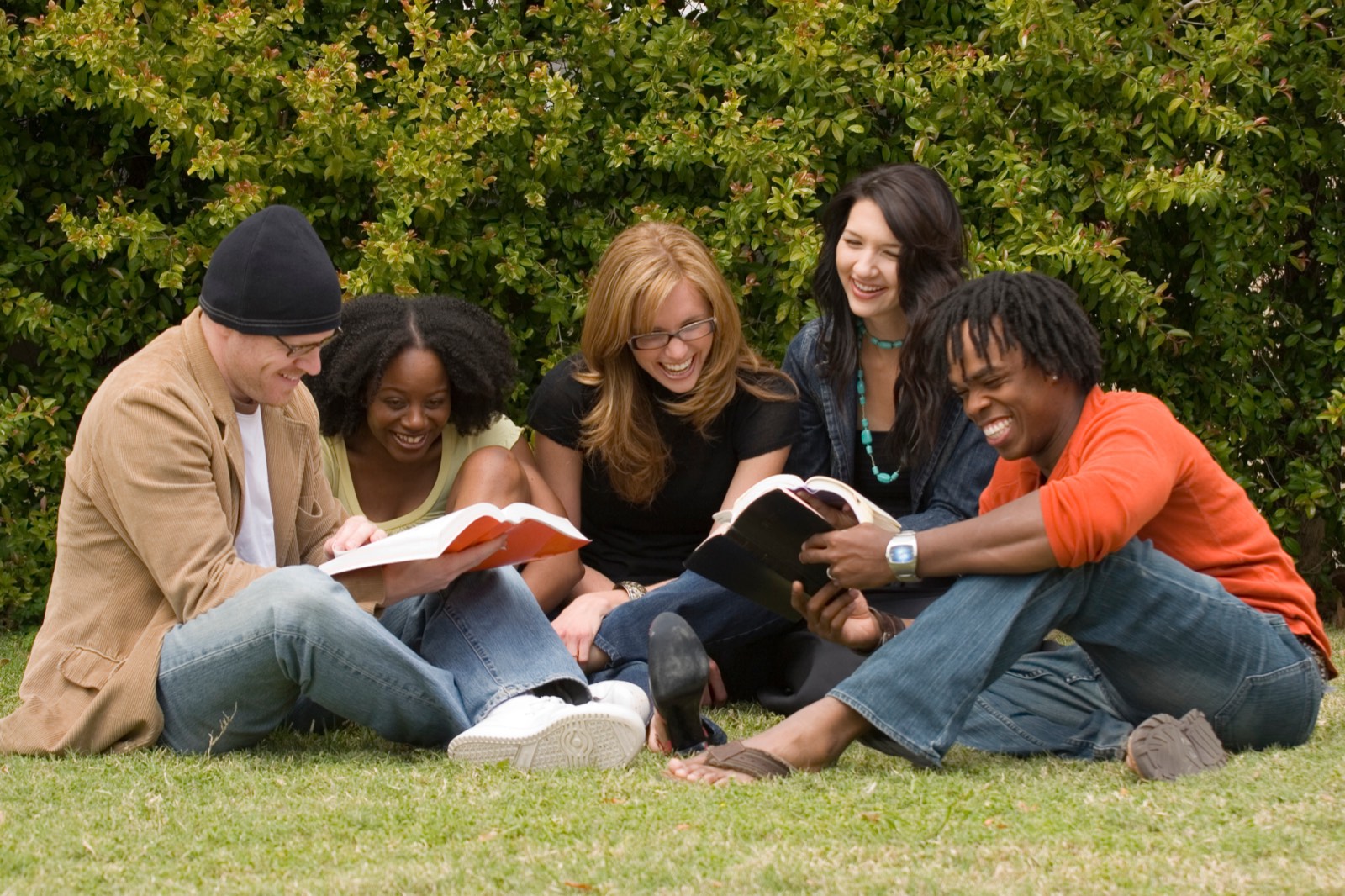 Friends reading together outdoors