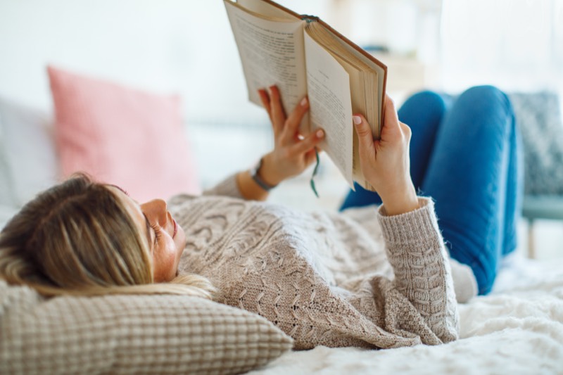 A woman resting while reading a book